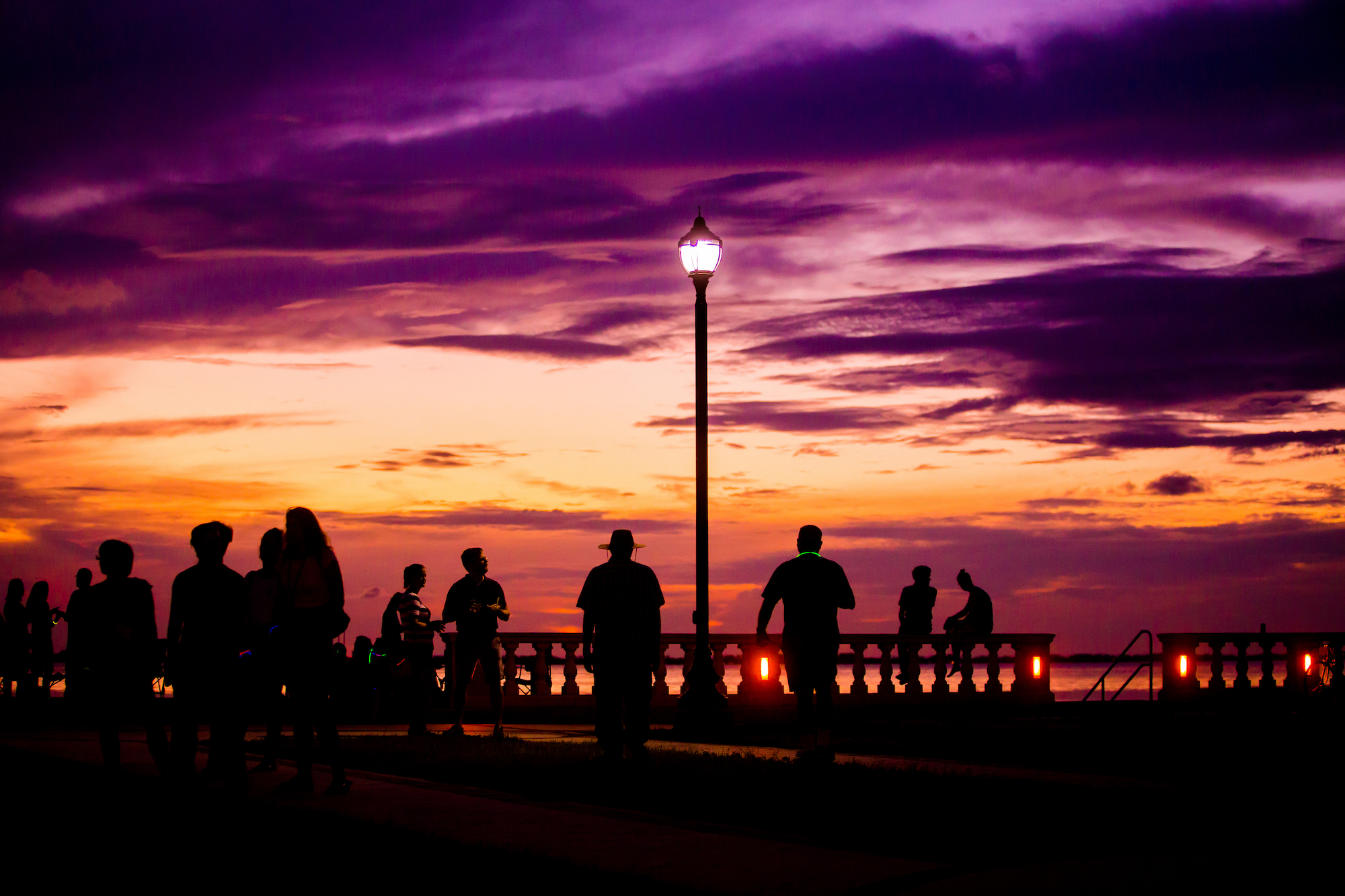 Students watch sunset at the bay shore