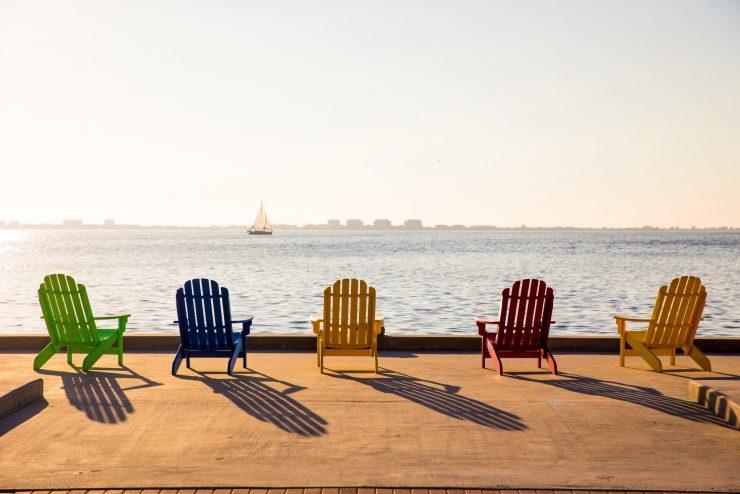 Adirondack chairs on the bay